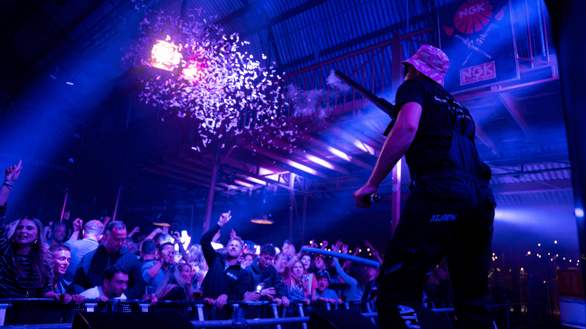 Performer on the ATJOOW X SOLEXRACE stage firing confetti toward the crowd